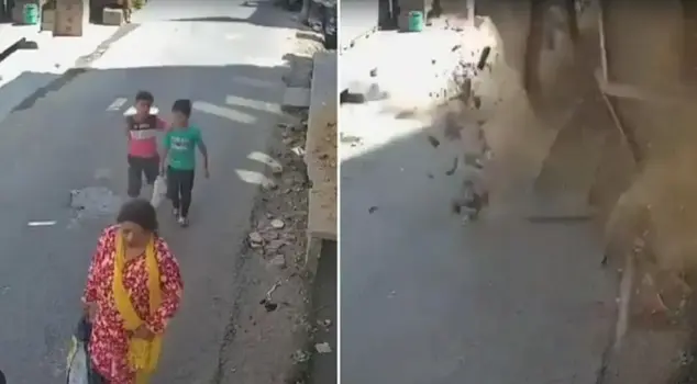 Two children walking on the street narrowly escaped being trapped under the collapsed building by just seconds.