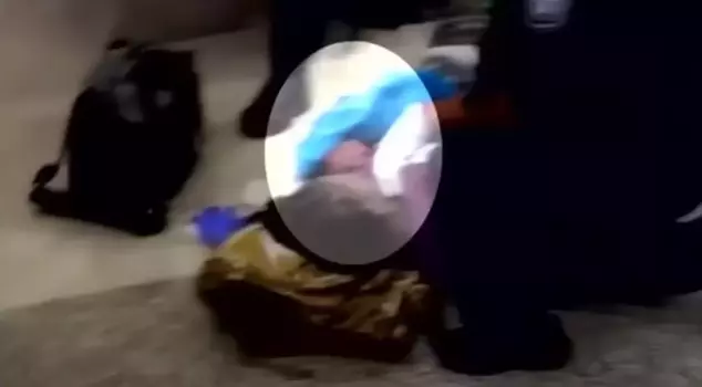 The young mother gave birth while waiting in line for her ticket at the airport.