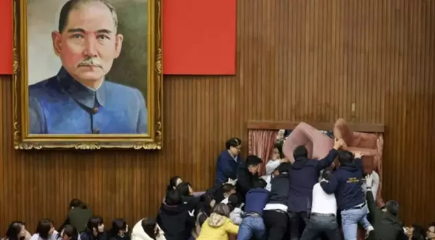 In the Taiwanese parliament, chairs flew through the air.