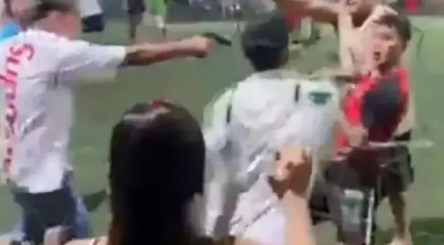 The youth match turned chaotic! A fan ran onto the field and pulled a gun on a player.