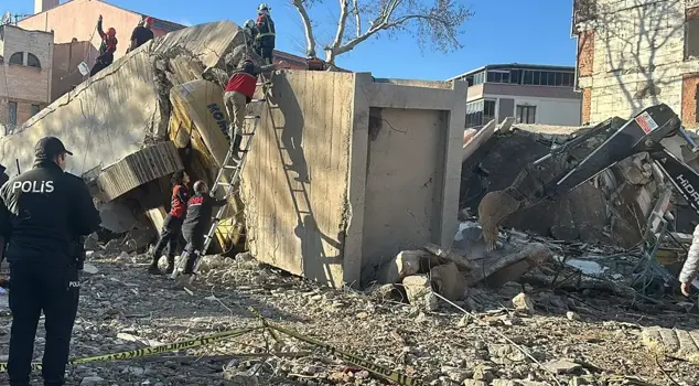 A 4-story building has collapsed, and the construction machinery operator is trapped under the rubble.