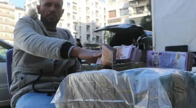 In Syria, money changers are exchanging bundles of cash on the streets.