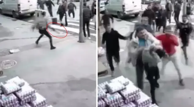 The person performing strange movements in the middle of the street is being beaten up.