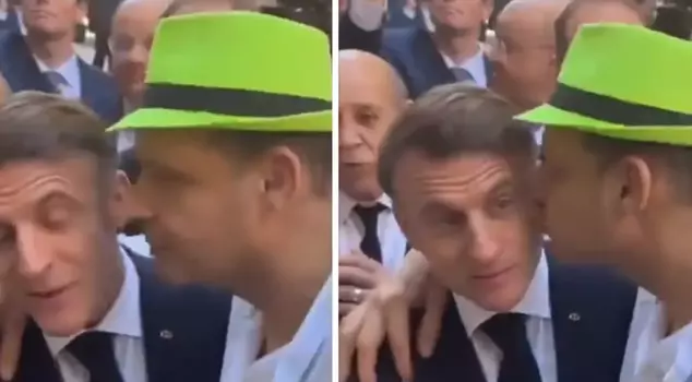 A person kissed French President Macron on the cheek.