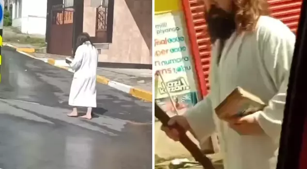 He walked barefoot in the street with a staff in one hand and a book in the other.