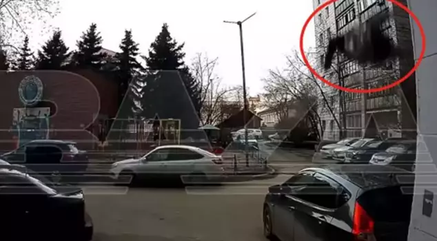 An 80-year-old woman fell from the 6th floor onto vehicles while cleaning a window.