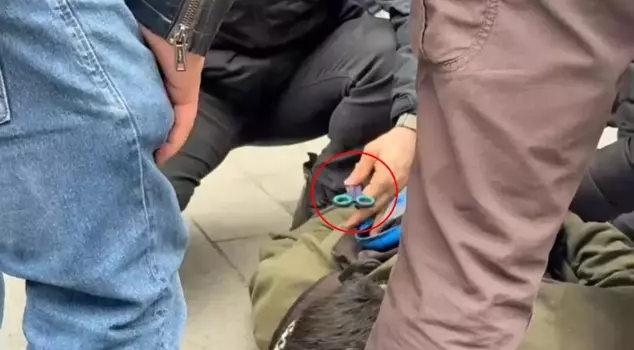 The protester's response, after pulling scissors out of their bag, even surprised the police: 