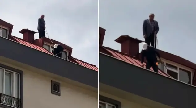 The worker doing the roof renovation took safety precautions by tying a rope around his waist.