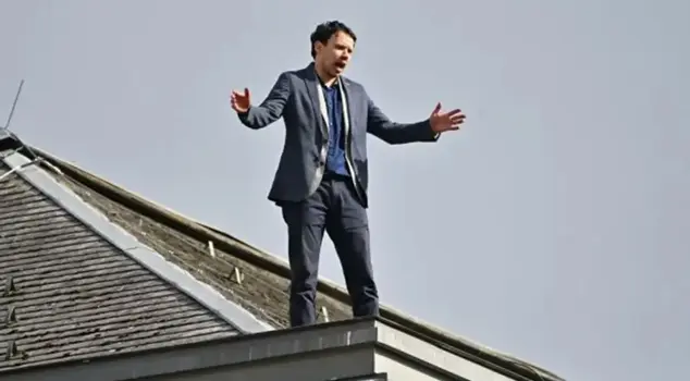 A dissenting member of parliament in Slovenia attempted suicide by climbing onto the roof of the parliament building.