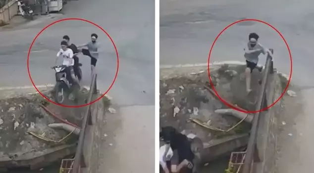 He narrowly escaped falling into the irrigation canal by grabbing onto the bridge from the motorcycle that flew off.