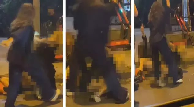 A woman knocked down two other women in the middle of the street and punched them.