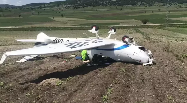 The training aircraft overturned while making an emergency landing.