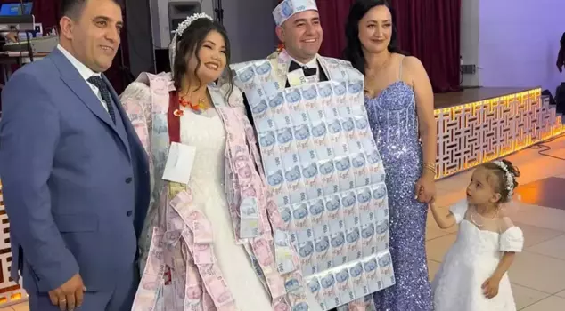 At the wedding, they dressed the groom in a vest made of money.