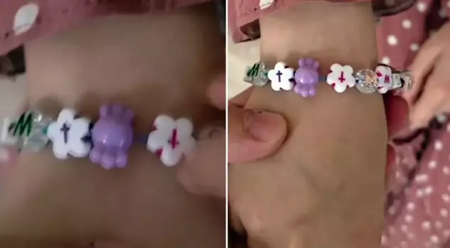 Parents react to the cross-marked wristband in the school cafeteria.