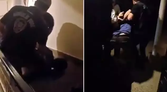 The cartoonist at the center of the reactions is handcuffed.