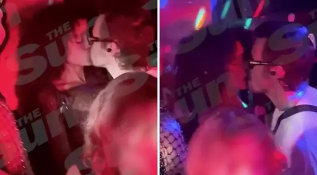 The famous singer was spotted kissing a mysterious woman.