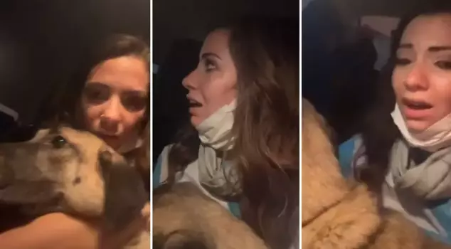 She escaped from the flames like this with the dog in her arms.