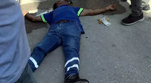 The father and son threw trash from the balcony onto the street and assaulted the sanitation worker.