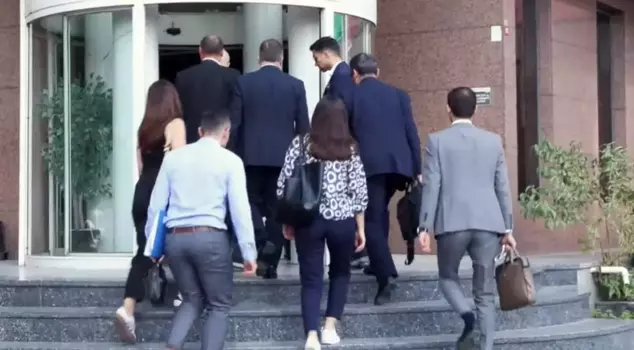 The trustee committee entered the Can Holding building like this.