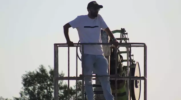 The president, who received a one-year ban, watched the match from the crane he rented.