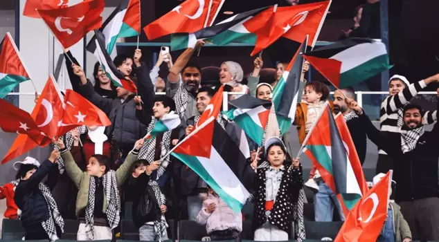 Palestinian children and their escorts are in the stands for the Turkey-Georgia match.