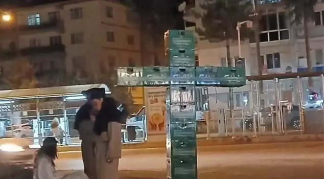 Three people were detained for making a cross sign with beer crates.