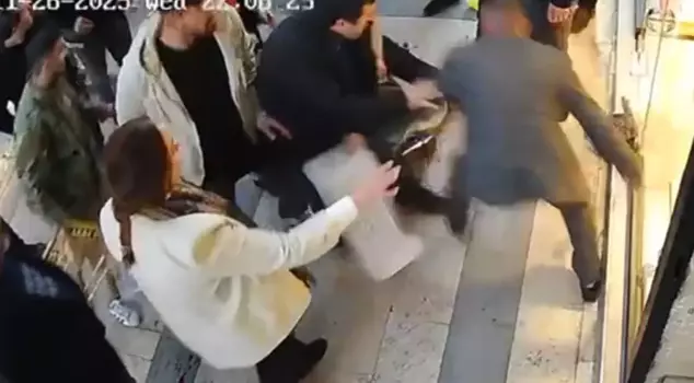 The woman who was attacked with a knife was rescued by shopkeepers using fruit crates.