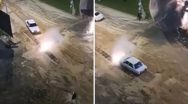 He turned the crisis into an opportunity and washed his vehicle in the flooded water.
