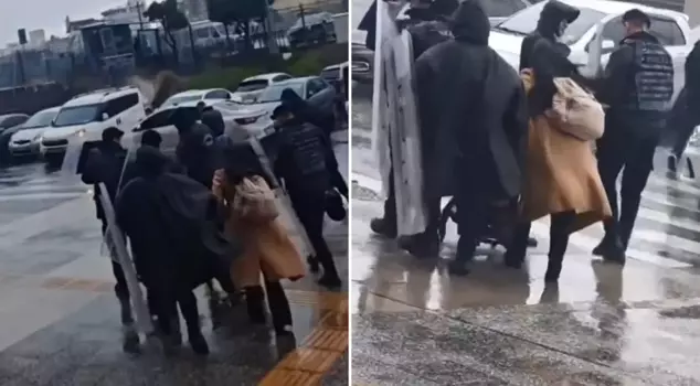 The riot police came to the aid of a mother with a baby who couldn't walk in the storm.