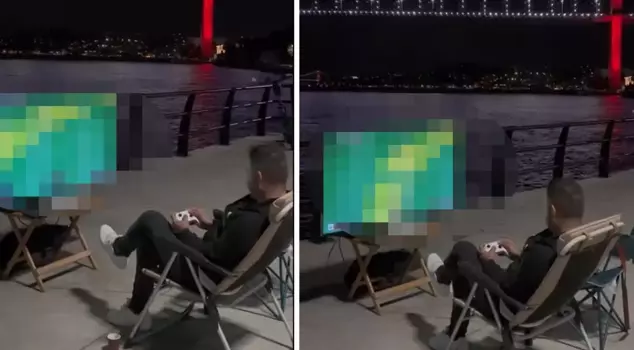 He played video games against the backdrop of the bridge and the strait view.