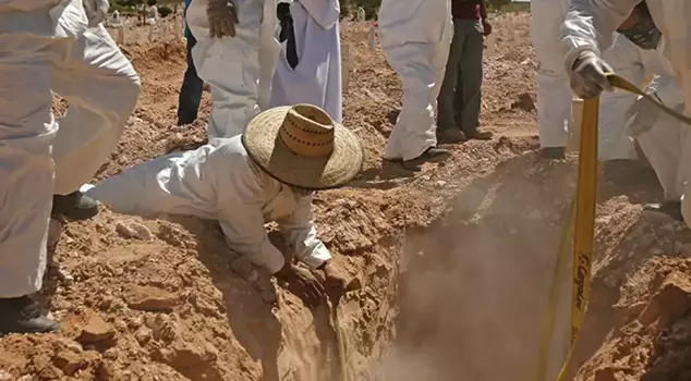 The bodies of miners who were killed under the suspicion of being gang members were found in a secret grave.