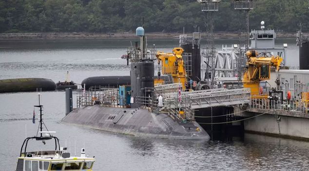 Two people detained for attempting to enter a base in England where nuclear submarines are located.