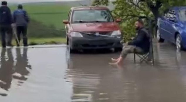 He tried to fish with a rod on the road that turned into a lake.