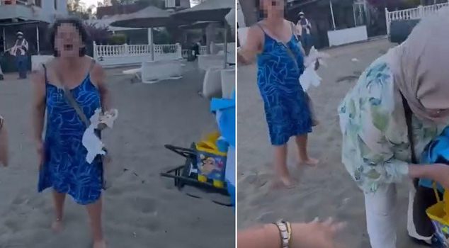 A woman who verbally attacked a mother and her daughter in headscarves on the beach has been taken into custody.