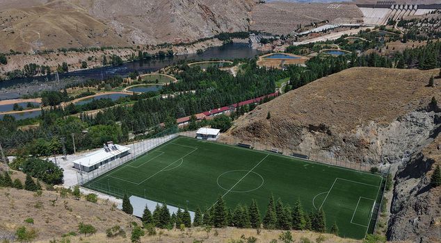 A stadium at the foot of the mountain overlooking Keban Dam Lake.