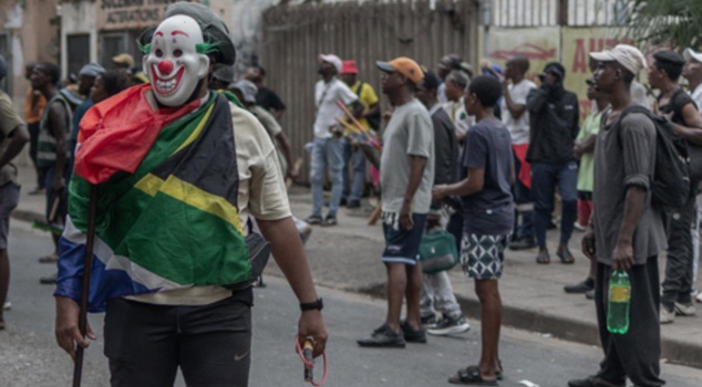 In South Africa, a crowd of 50 people beat a foreigner to death in the street.