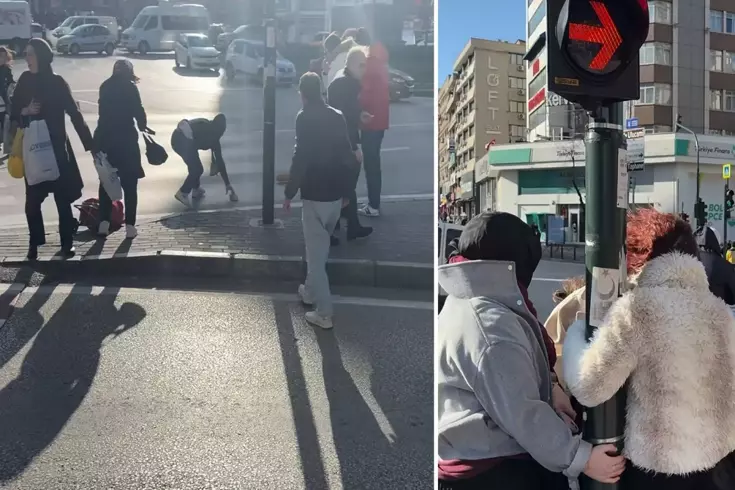 Fırtınada zor anlar: Uçmamak için trafik direğine tutundular