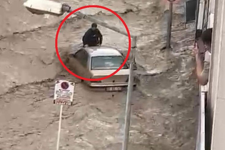 In Havza, on top of a vehicle swept away by floodwaters, clinging to life.