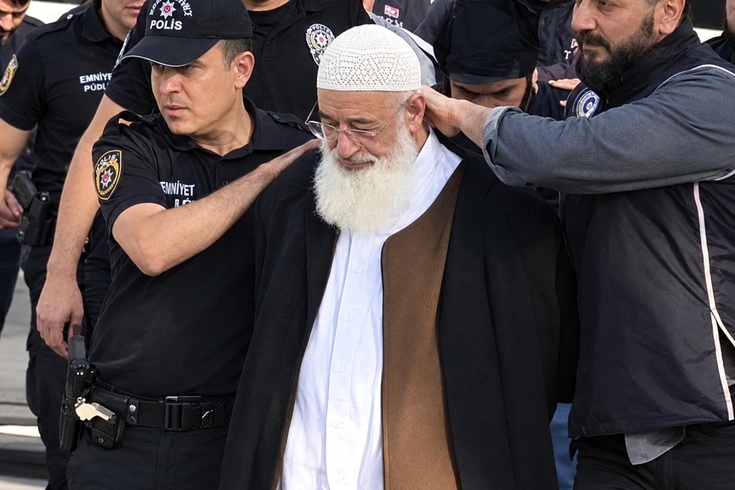The 69-year-old writer was detained with their hands cuffed behind their back during an ISIS operation! An investigation has been launched into the footage.