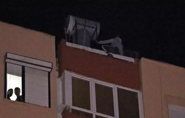 12 katlı apartmanın çatısından aşağı sarkan genç kadını film izler gibi izlediler 12 katlı apartmanın çatısından aşağı sarkan genç kadını film izler gibi izlediler