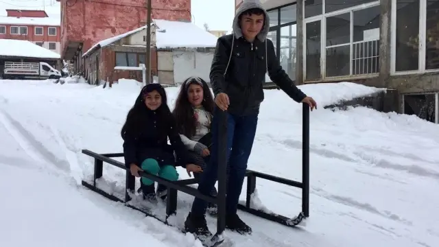 Karlıova'da çocuklar, karda kızakla eğlendi