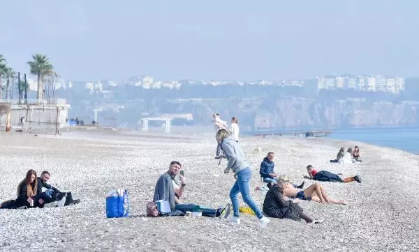 Kısıtlamada turistlerin sahilde güneş keyfi Kısıtlamada turistlerin sahilde güneş keyfi