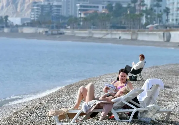 Kısıtlamada turistlerin sahilde güneş keyfi Kısıtlamada turistlerin sahilde güneş keyfi