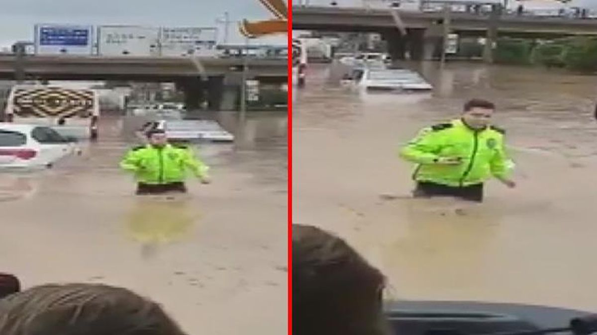 Beline kadar suya girip mahsur kalanları kurtarmaya çalışan komiserin görüntüleri büyük beğeni topladı