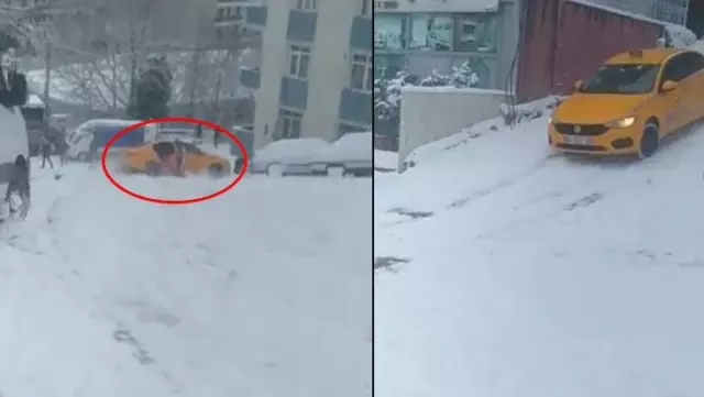 Karda kayan taksiden atlayan yolcu kamerada Karda kayan taksiden atlayan yolcu kamerada