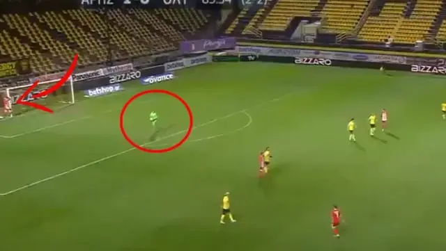 Awake football player hiding next to the goal post caught the goalkeeper by surprise