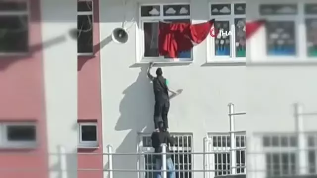 Katlanan bayrağı düzeltmek içi kedilerini tehlikeye attılar