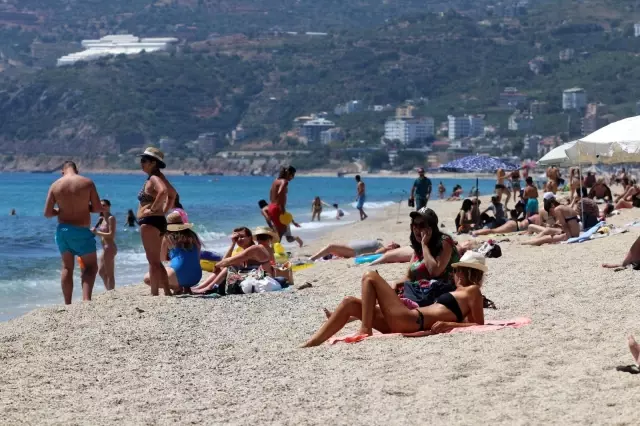 Alanya'da aşırı nem ve sıcak havayı fırsat bilenler sahillere akın etti Alanya'da aşırı nem ve sıcak havayı fırsat bilenler sahillere akın etti