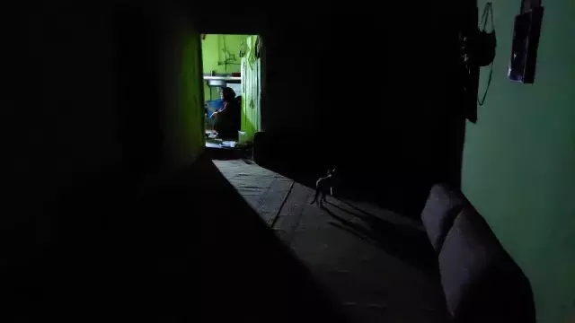 Elektriklerin 4 saat kesildiği köyde seyyar lambanın ışığında yemek yiyorlar