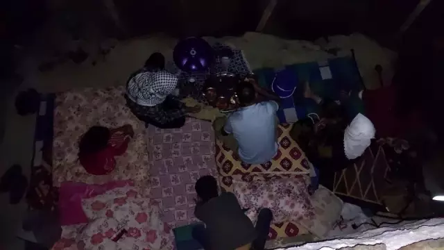 Elektriklerin 4 saat kesildiği köyde seyyar lambanın ışığında yemek yiyorlar
